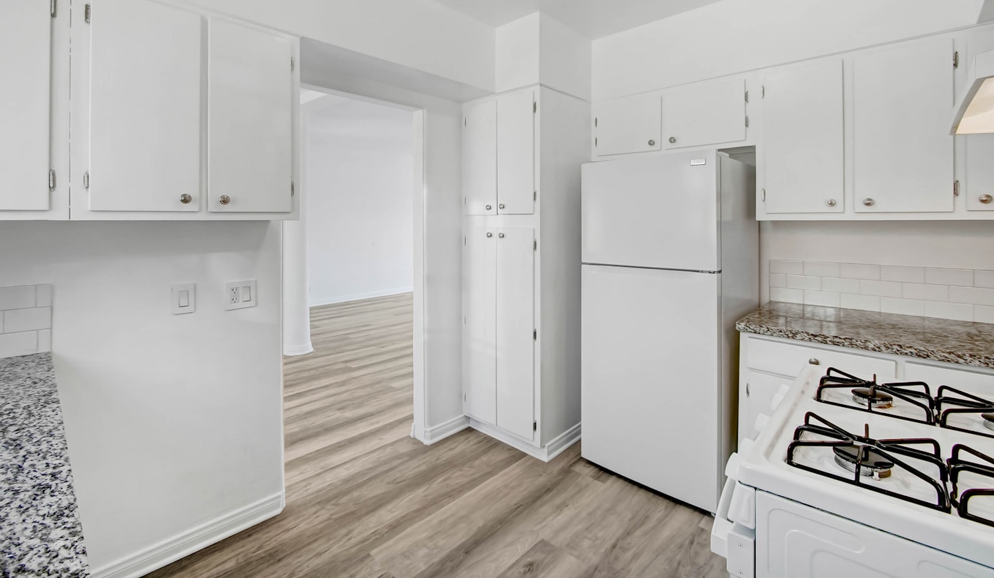 White apartment kitchen with granite counters