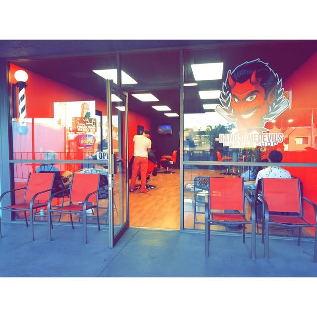 The red-and-black Handsome Devils storefront and barber pole