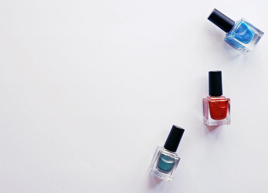 Red, blue, and teal polish bottles